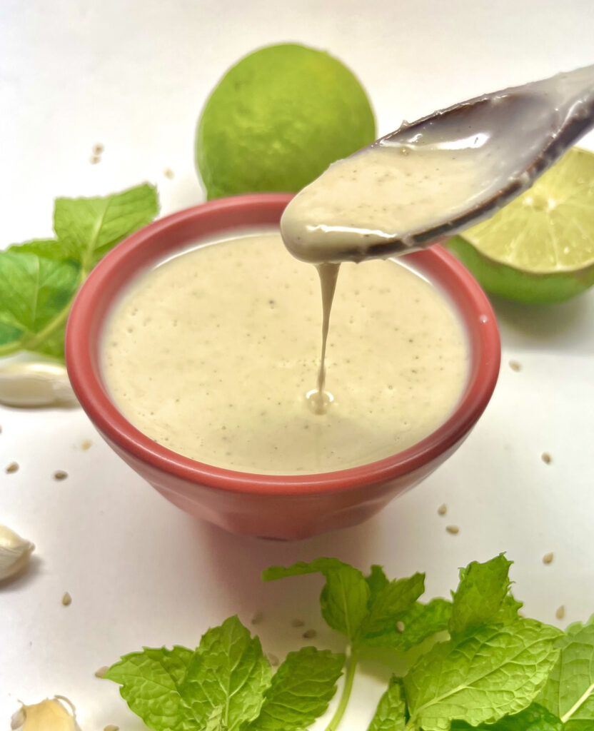 dressing in cup with spoon