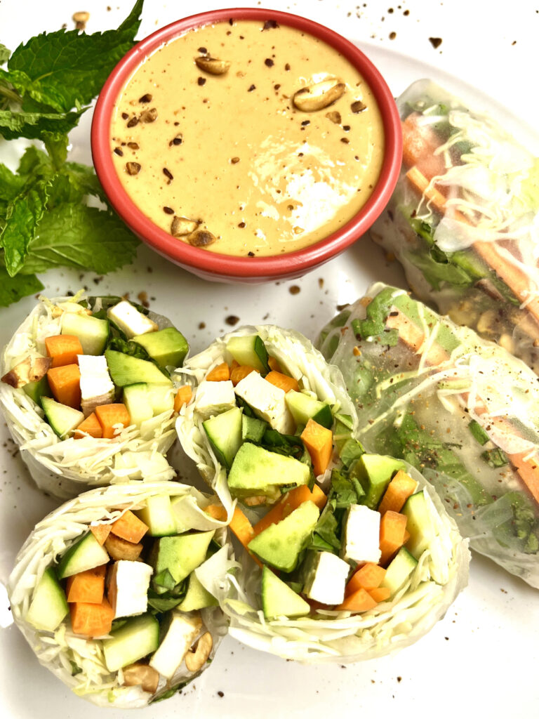 spring rolls on plate with peanut sauce