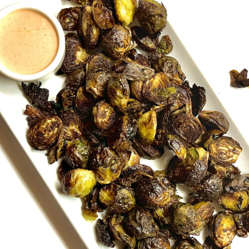 roasted brussel sprouts on platter with spicy mayo