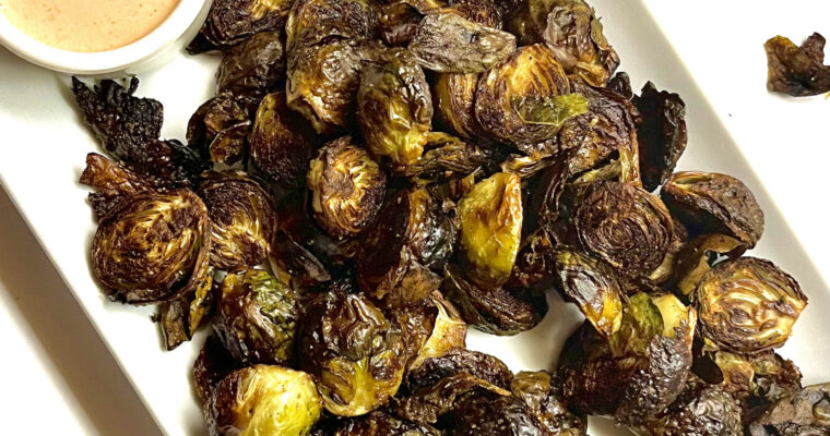 roasted brussel sprouts on platter with spicy mayo