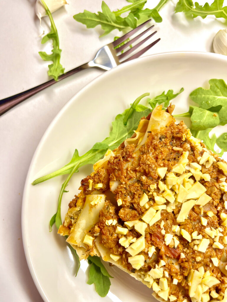 lasagna slice on plate with fork