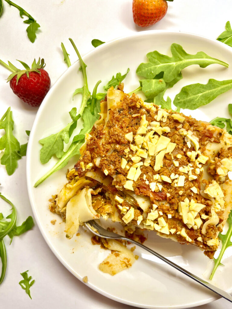 slice of lasagna on plate with fork