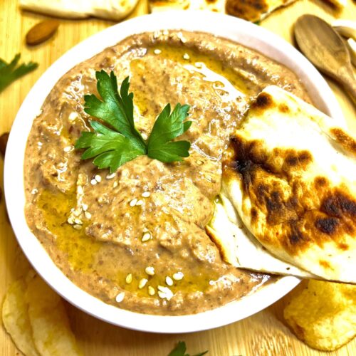 hummus in bowl with pita