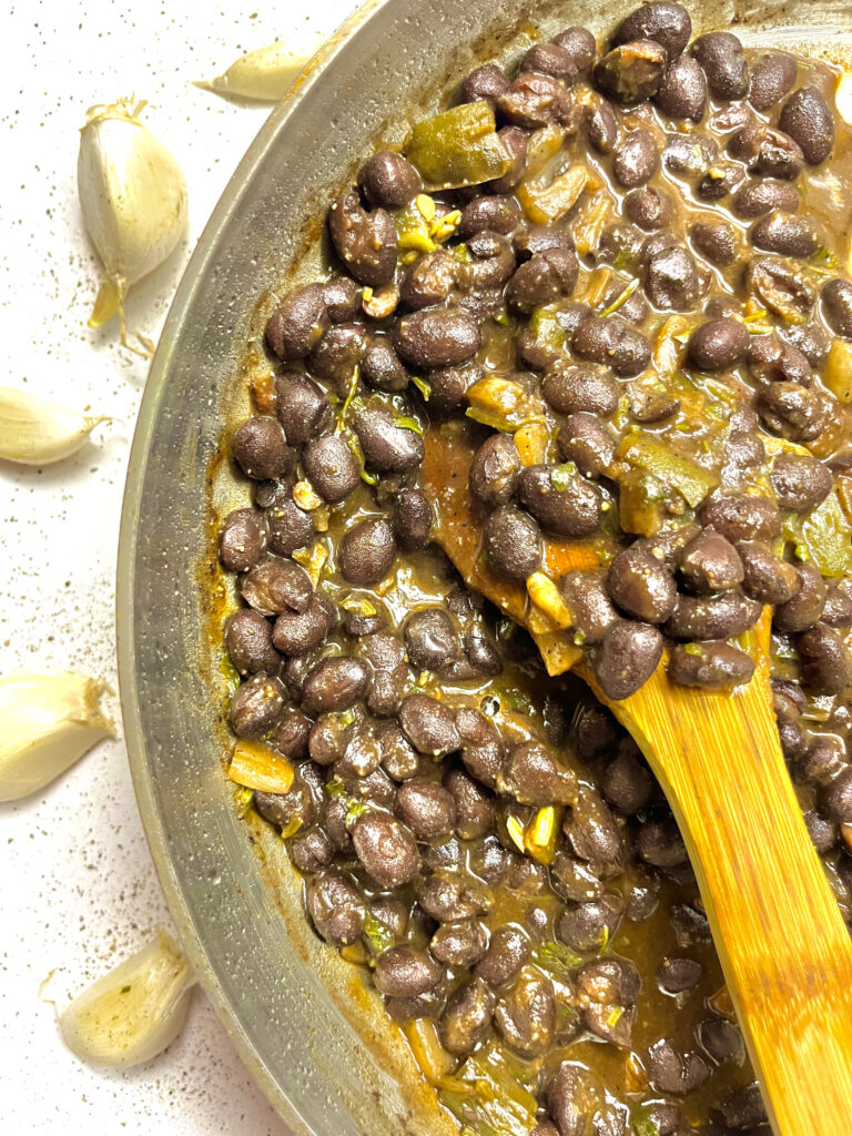 black beans in pan with spoon