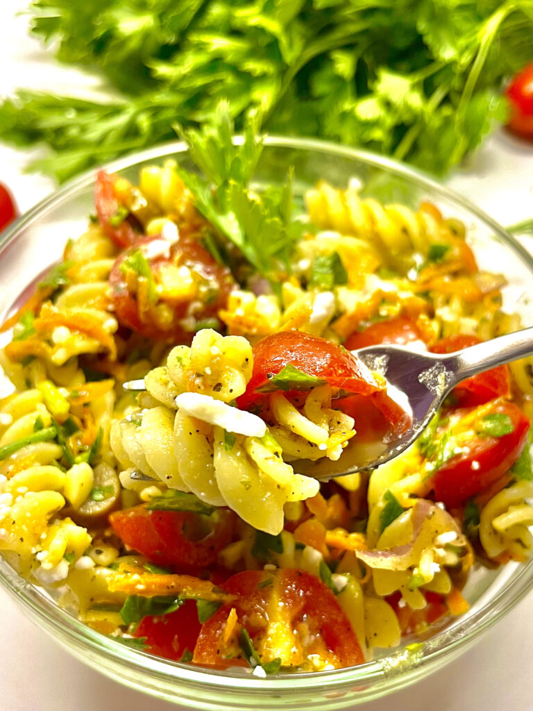 pasta salad in bowl with spoon