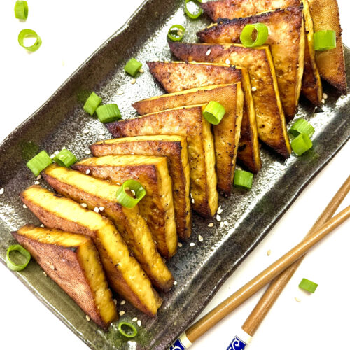 tofu steaks on plate with chopsticks