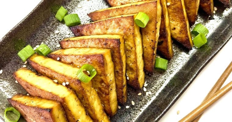 tofu steaks on plate with chopsticks