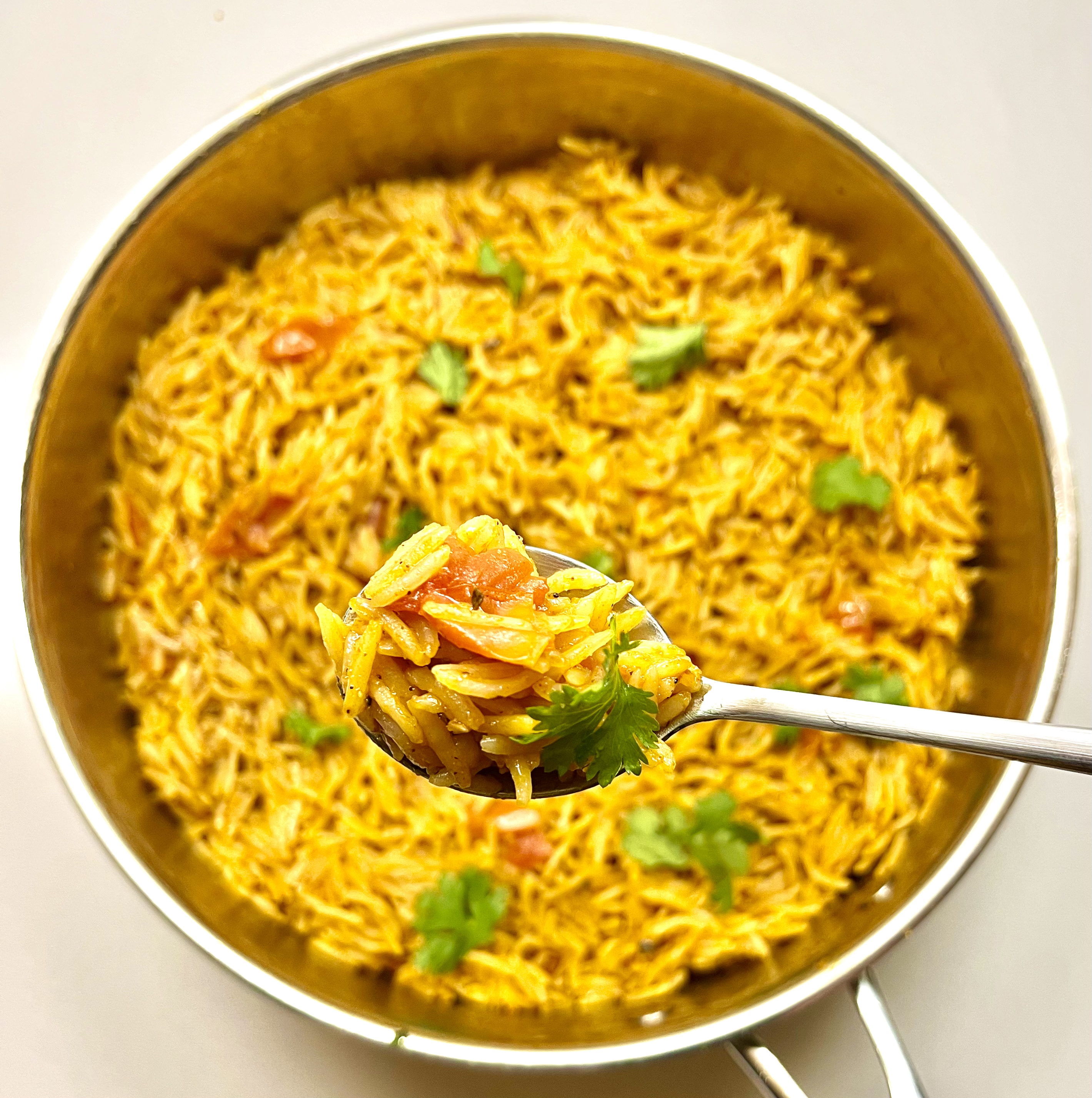 spanish rice in pot with spoon