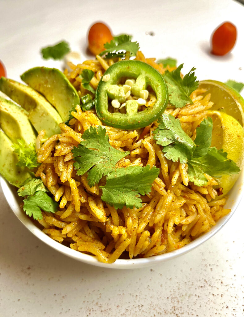 spanish rice in bowl with garnishes