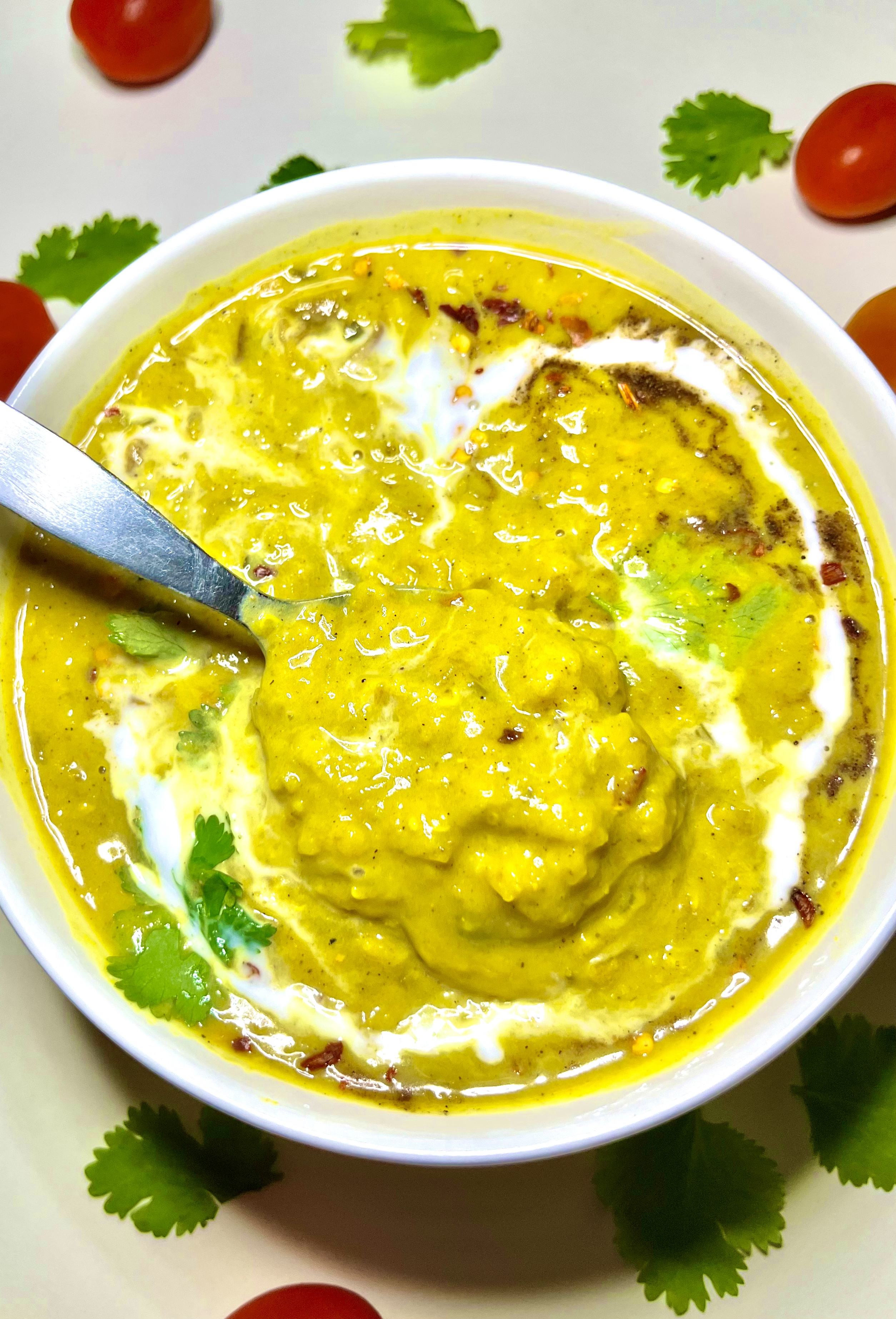 coconut curry lentil soup in bowl with spoon