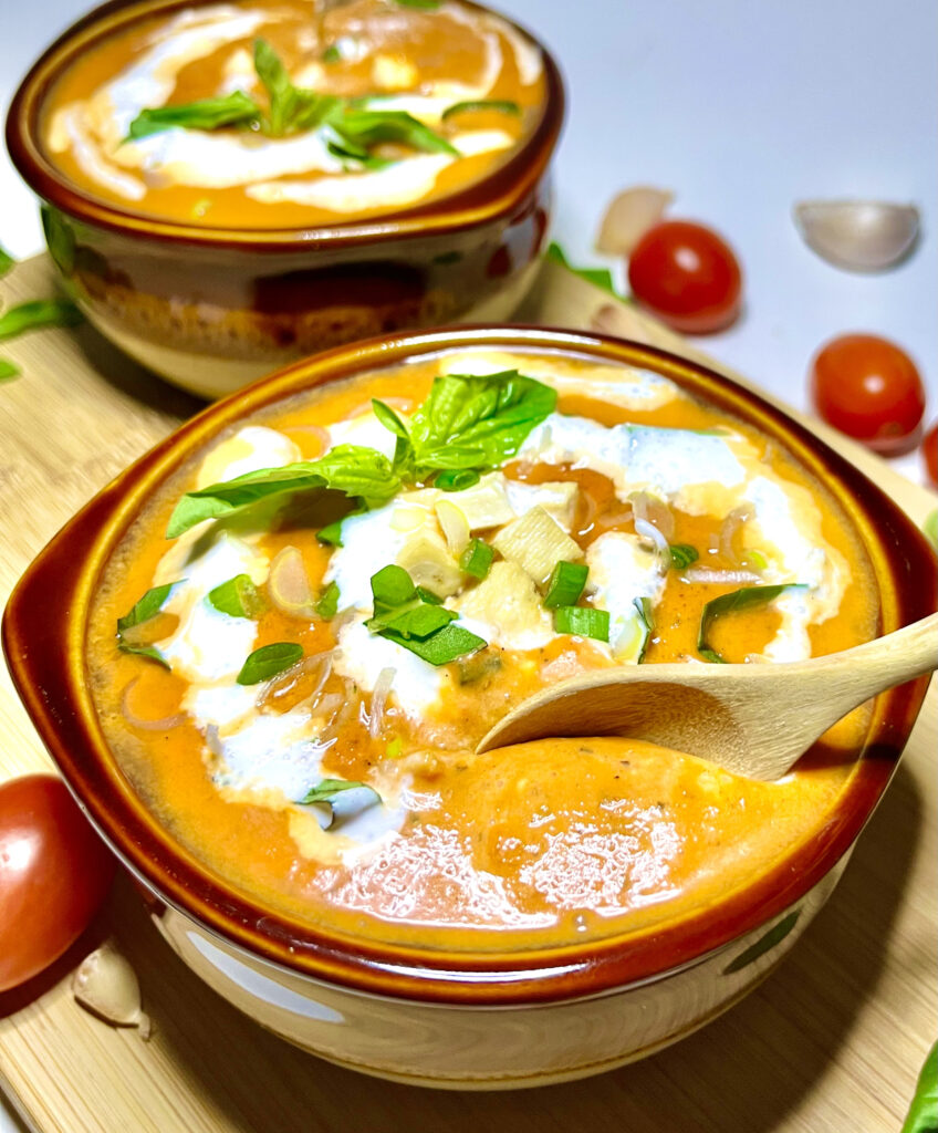 roasted red pepper soup in bowl with spoon