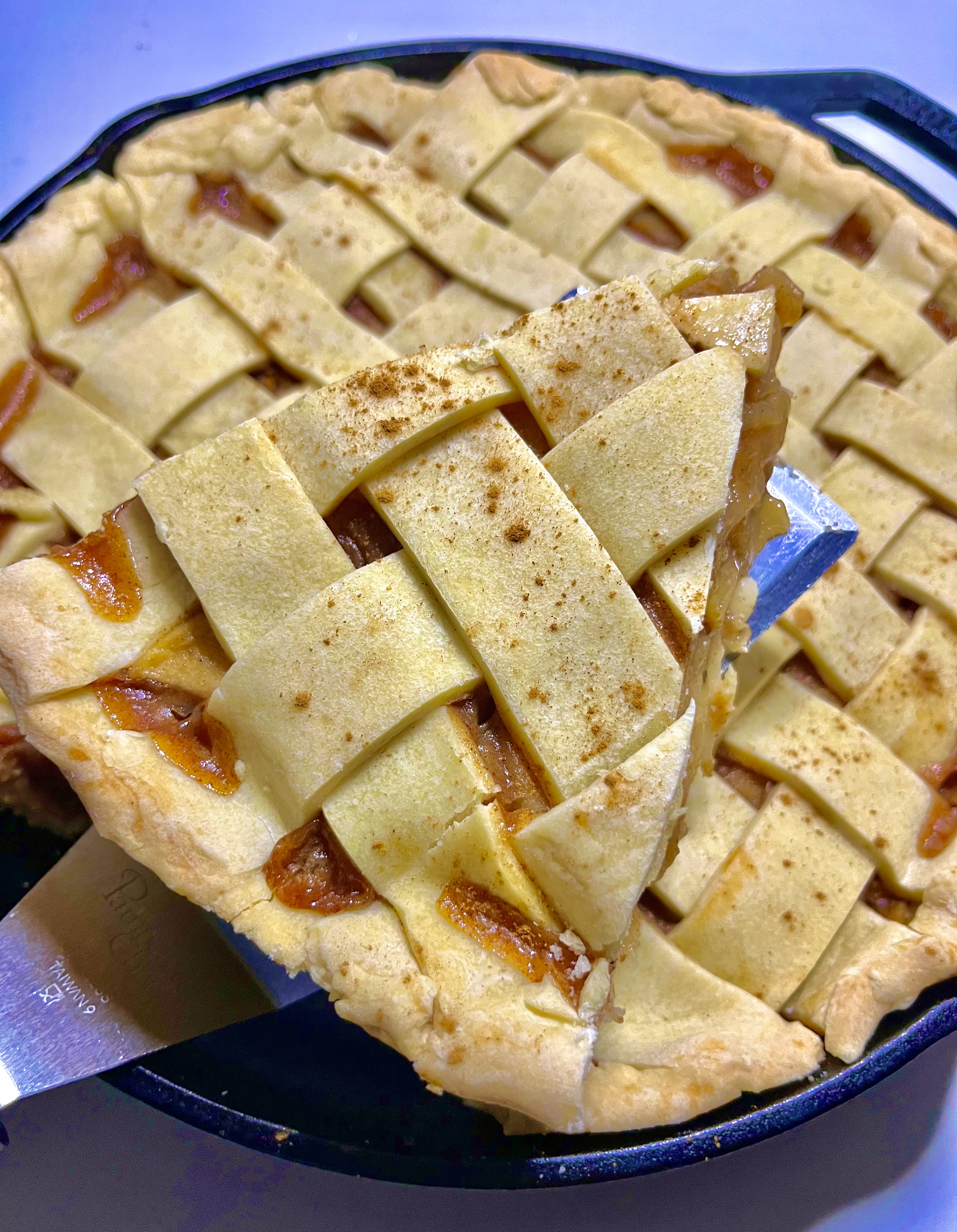 apple pie with slice being lifted from pie