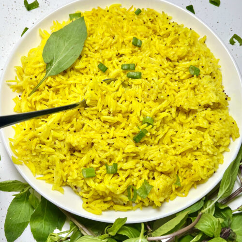 coconut turmeric rice on plate with spoon