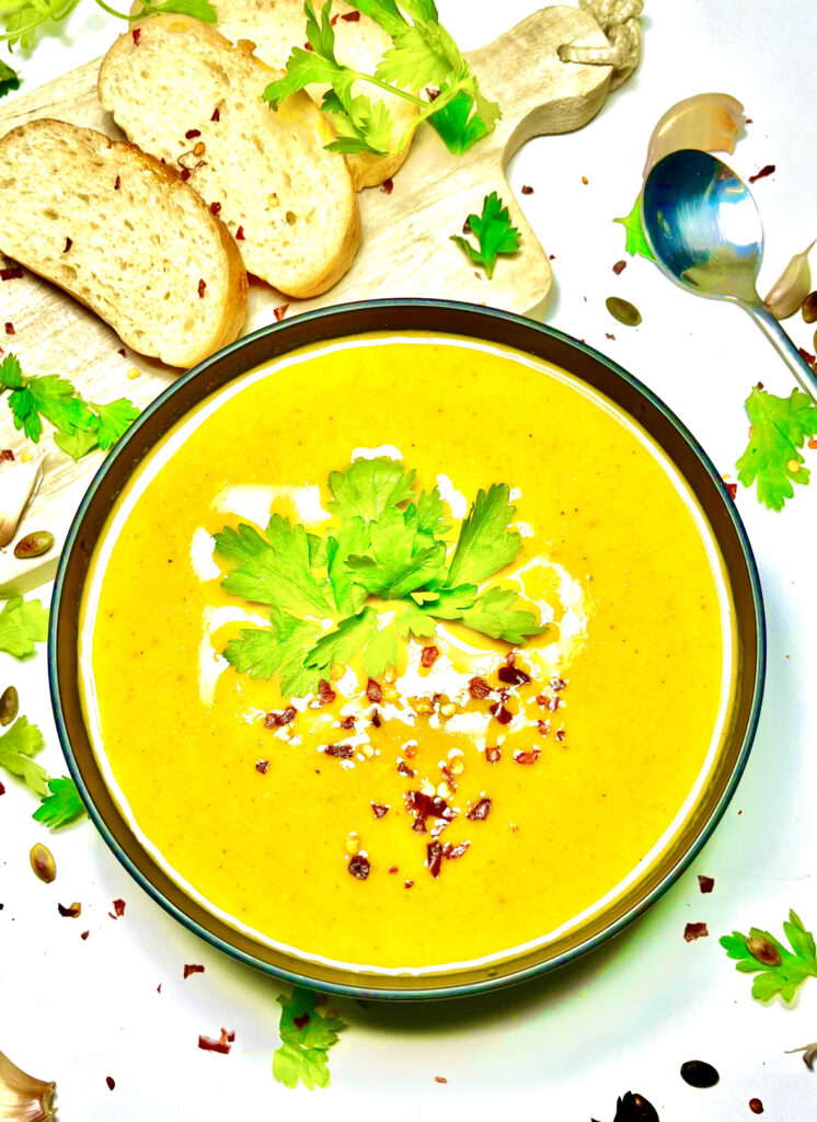 creamy broccoli lentil soup in bowl with bread