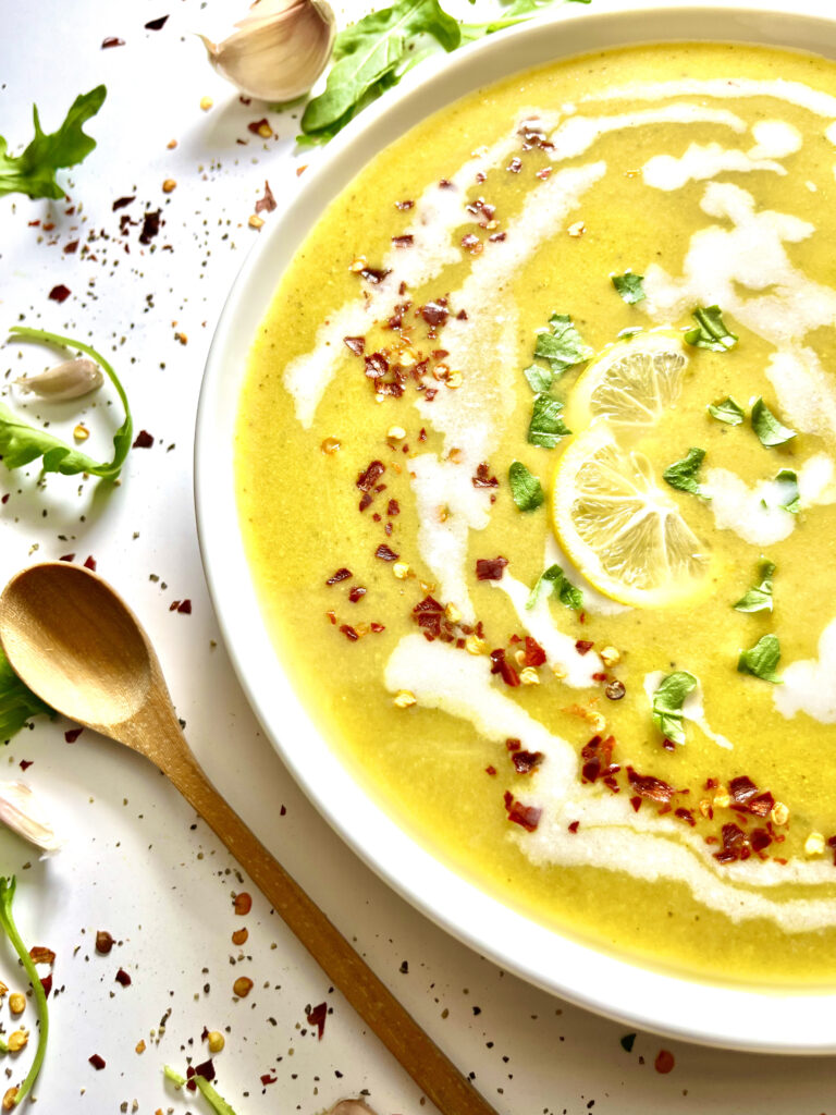 creamy broccoli lentil soup with long wooden spoon