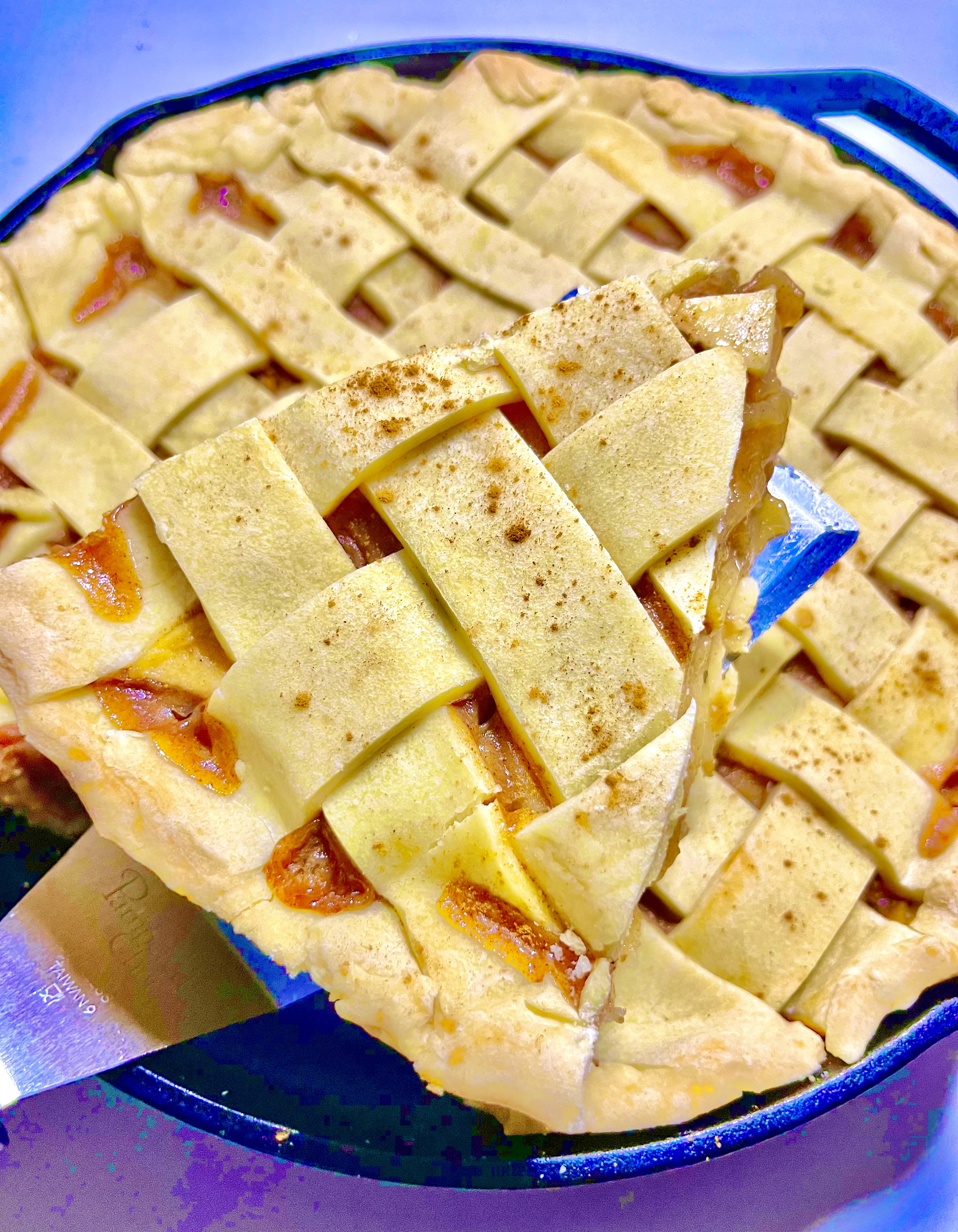 apple pie with slice being lifted from pie