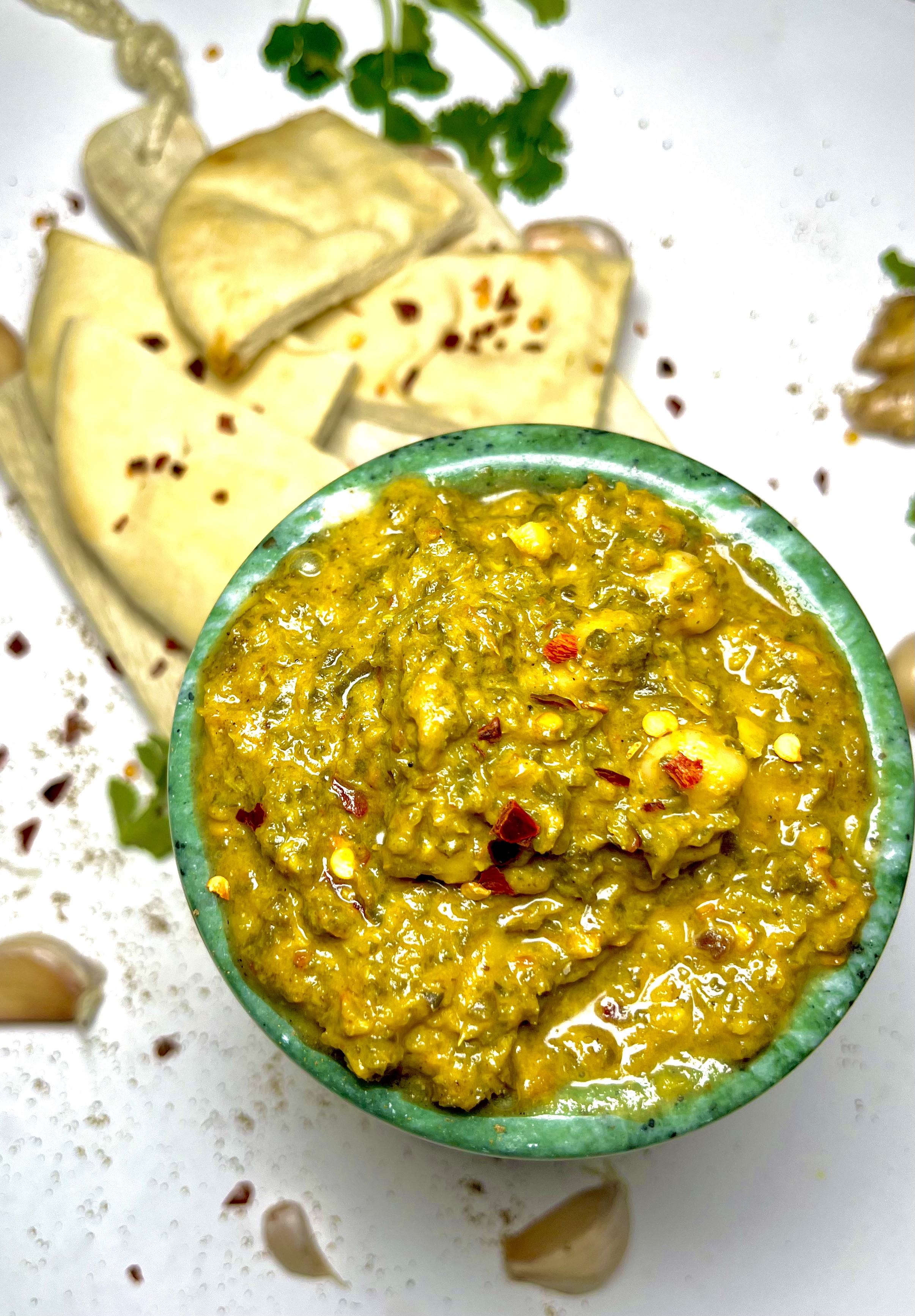 creamy kale saag in bowl with naan